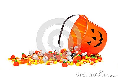 Halloween Jack o Lantern candy collector with spilling candy over white Stock Photo