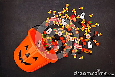 Halloween Jack o Lantern pail, top view with spilling candy Stock Photo