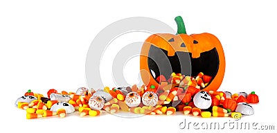 Halloween jack o lantern wide mouth bowl with spilling candy border isolated on white Stock Photo