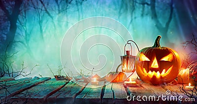 Halloween - Jack O` Lanterns And Candles On Table Stock Photo