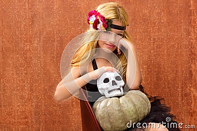 Halloween kid girl with pumpkin and skull smiling Stock Photo