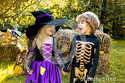 Halloween kids holidays concept. Halloween party with children wearing Halloween costumes. Happy children with skeleton Stock Photo