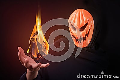 Halloween man with pumpkin mask control fireball Stock Photo