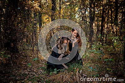 Halloween Maniac and Witch in the Forest Stock Photo