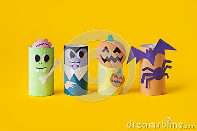 Halloween monster toy from toilet paper tube. Pumpkin jack, zombie, vampire, bat, spider on yellow or orange background Stock Photo