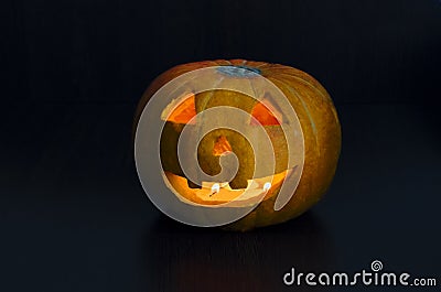 Halloween orange pumpkin with burning candles on a dark background. jack o lantern. traditional western culture. Stock Photo