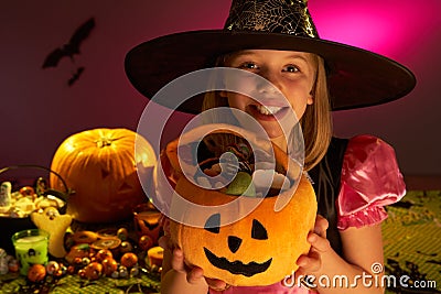 Halloween party with a child showing candy Stock Photo