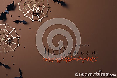 Halloween party decorations from bats, spider web and confetti. Minimal holiday greeting card with text happy halloween Stock Photo