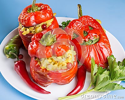 Halloween party food. Red stuffed peppers with scary cutout faces close up Stock Photo