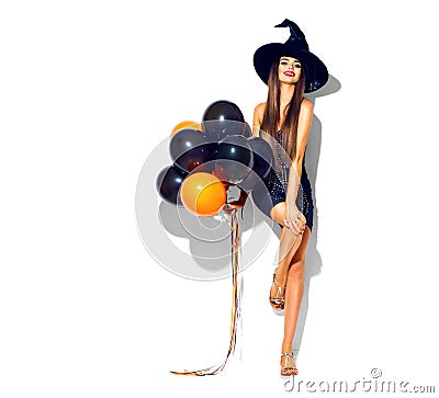 Halloween party girl. witch holding black and orange air balloons Stock Photo