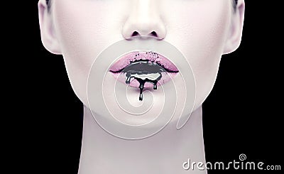 Halloween party makeup, gothic style. Black paint dripping from the lips of beautiful model girl. Beauty woman face Stock Photo