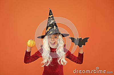 Halloween party. Small girl in black witch hat. Autumn holiday. Join celebration. Halloween attributes. Little child in Stock Photo