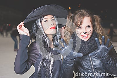 Halloween party! Young women like witch and cat role Stock Photo