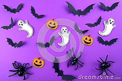 Halloween pattern concept. Flying black paper bats , pumpkins and ghosts, on purple background Stock Photo