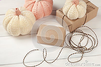 Halloween preparation. Halloween background with decorative pumpkin, gift box on white wooden background. Festive concept. Stock Photo