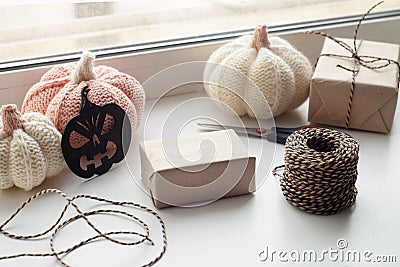 Halloween preparation. Craft halloween gift boxes on the window sill. Holidays, decoration and party concept - home room Stock Photo