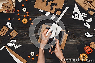 Halloween preparation. Hands making halloween cards and decoration using craft paper Stock Photo