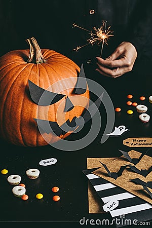 Halloween preparation. Hands making halloween cards using craft paper Stock Photo