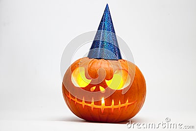 Halloween pumpkin head jack lantern with burning candles with festive hubcap isolated on white background Stock Photo