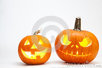 Two Halloween pumpkin head jack lantern with burning candles isolated on white background Stock Photo