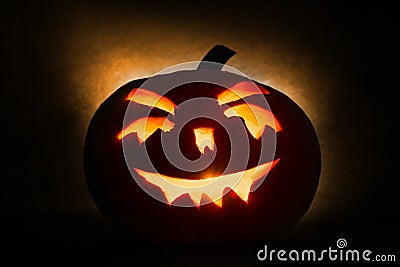 Halloween pumpkin head jack lantern with burning candles on orange background Stock Photo