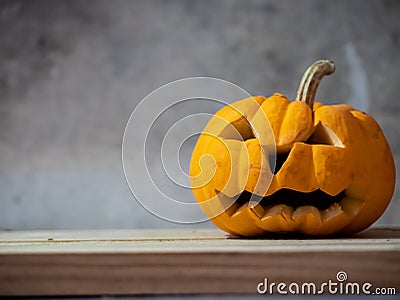 Halloween pumpkin head jack lantern on wooden table Stock Photo