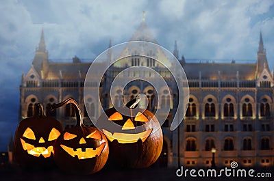 Halloween pumpkin head jack lanterns in front of ancient spooky castle Stock Photo