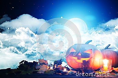 Halloween pumpkin Jack-o`-lantern on wooden table with candles in a spooky night over moon and clouds Stock Photo