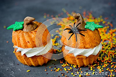 Halloween pumpkin recipe - orange cupcakes in the shape of pumpkin with cream Stock Photo