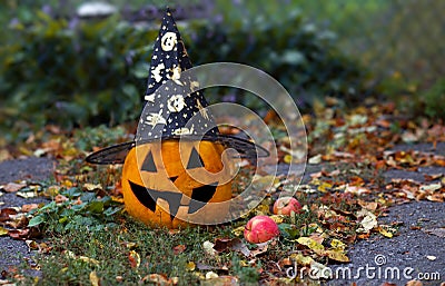 Halloween pumpkin in whitch hain in the garden Stock Photo