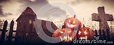 Halloween pumpkins in gothic scenery with hunted house and grave Stock Photo