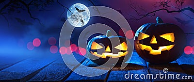 Halloween Pumpkins On Wood In A Spooky Forest At Night Stock Photo