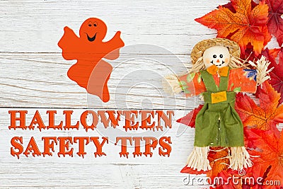 Halloween safety tips message with red and orange fall leaves with a scarecrow Stock Photo