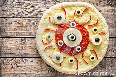 Halloween scary food funny eye monster pizza horror with mozzarella and tomato Stock Photo