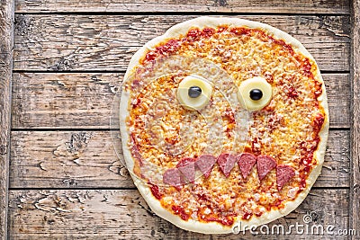 Halloween scary food funny monster face pizza horror snack with mozzarella Stock Photo