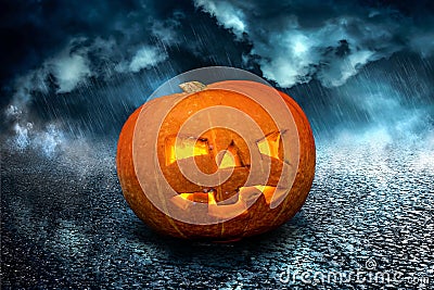 Halloween scary Night Pumpkin on dramatic dark creepy sky background. Halloween horror Stock Photo