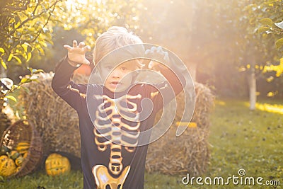 Halloween skeleton child. Halloween Kids Costume Party. Happy laughing child in costume to halloween. Funny kid in Stock Photo