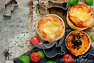 Halloween snack pizza for kids decorated cheese and olive Stock Photo