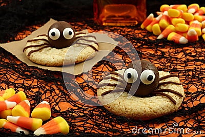 Halloween spider cookies on orange and black background Stock Photo