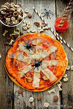 Halloween Spider Pizza with tomato sauce and cheese on a wooden Stock Photo