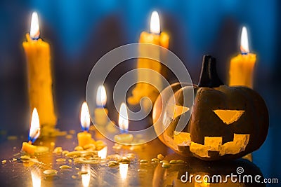 Halloween spooky Jack-O-Lantern pumpkin head with candles decoration at night background, selective focus Stock Photo