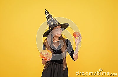 halloween teen girl in witch hat hold pumpkin jack o lantern for witchcraft, halloween traditions Stock Photo
