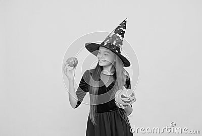 halloween teen girl in witch hat hold pumpkin jack o lantern for witchcraft, halloween traditions Stock Photo