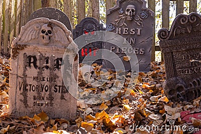 Decorated cemetery with tombstones, zombies and skeletal remains. Editorial Stock Photo