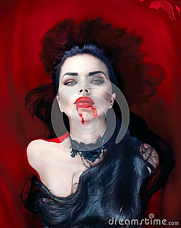 Halloween. Vampire woman lying in a bath full of blood Stock Photo