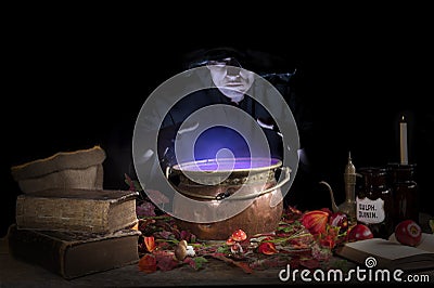 Halloween witch with cauldron Stock Photo