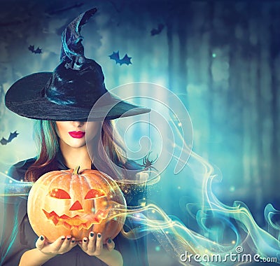 Halloween witch with a magic pumpkin Stock Photo