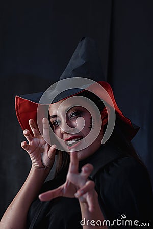 Halloween witch woman portrait, Fashion young woman going to party with spooky costume, makeup scary faces, having fun at Stock Photo