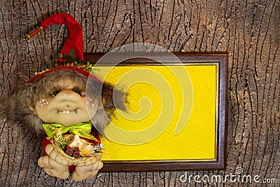 Halloween. Wooden frame with web and yellow paper blank space for recording. Witch toy with garlic, berry, money Stock Photo