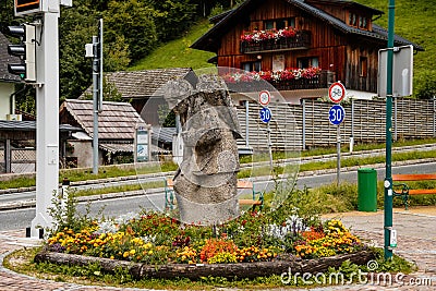 Hallstatt, Austria, 27 August 2021: stone statue of salt miner Colorful scenic picturesque town street at summer day, mountain Editorial Stock Photo
